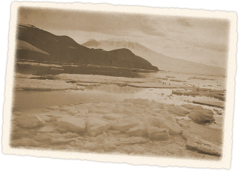 Still sea, Mount Erebus shrouded in clouds in background